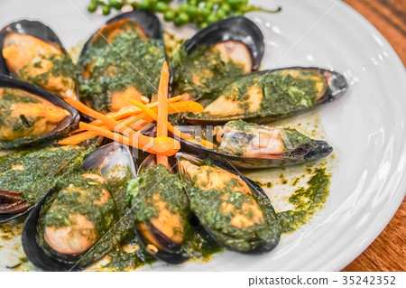 Baked mussels with carrot on plate 35242352