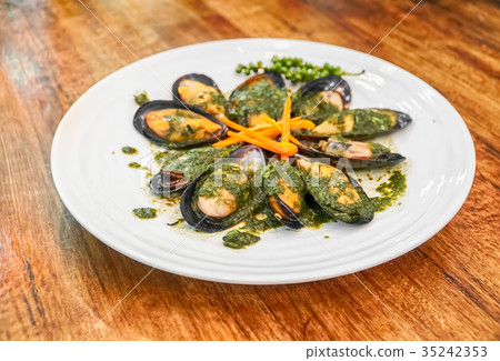 Baked mussels with carrot on plate 35242353