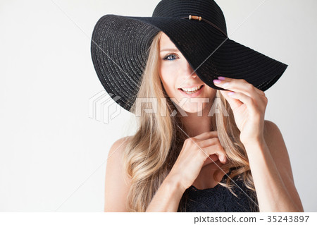 fashionable girl in a hat with a brim poses for 35243897