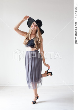 fashionable girl in a hat with a brim poses for fashionable girl in a hat with a brim poses for 35243899