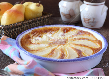 Pear clafoutis and yellow pears in wicker basket Pear clafoutis and yellow pears in wicker basket 35244590