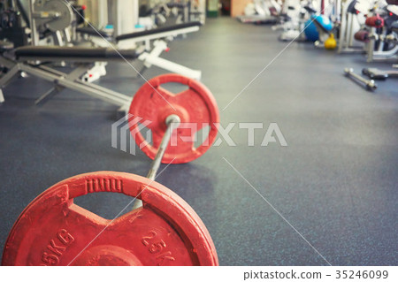 barbell on floor in empty gym barbell on floor in empty gym 35246099