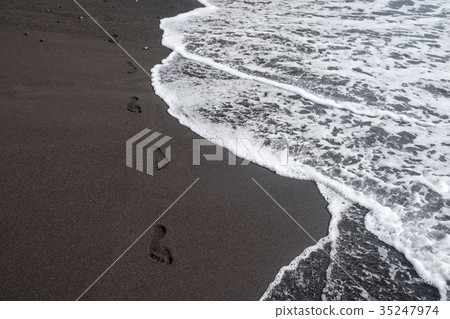 foot prints on black sand 35247974