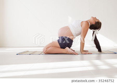 a pregnant woman is engaged in gymnastics and yoga 35248752