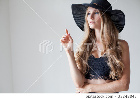 fashionable girl in a hat with a brim poses for fashionable girl in a hat with a brim poses for 35248845