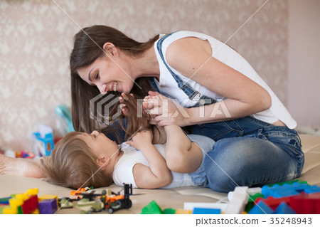 mom plays with a little boy with love kisses mom plays with a little boy with love kisses 35248943