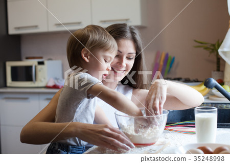 mother and son prepare pie with flour 35248998