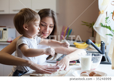 mother and son prepare pie with flour 35248999