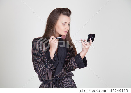 girl in coat makes brush makeup looks in the 35249163