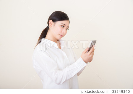 young asian woman using smart phone young asian woman using smart phone 35249340