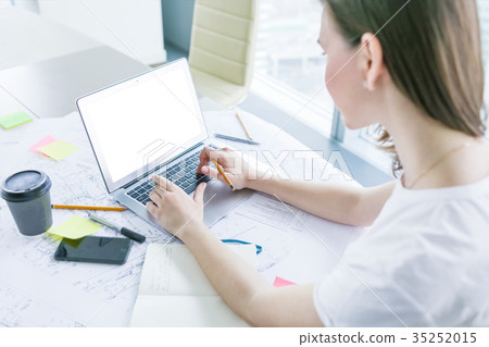 Young woman working on laptop at office 35252015