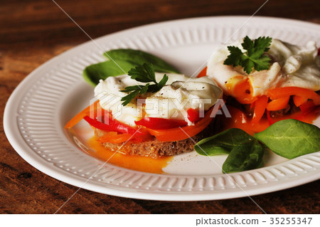 Eggs Benedict. Toasted muffins with paprika 35255347