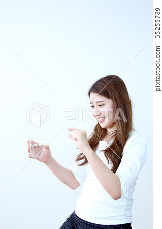 Young woman with pills 35255789