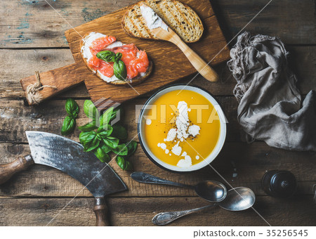 Dinner or lunch with pumpkin cream soup and toasts 35256545