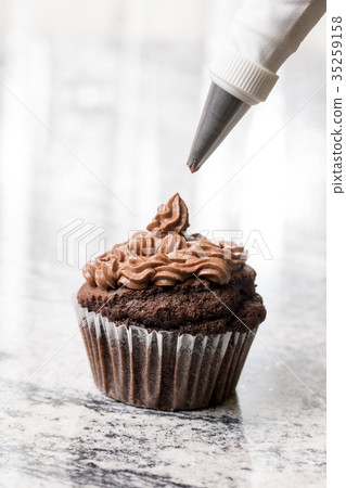 Piping bag with chocolate ganache cream Piping bag with chocolate ganache cream 35259158