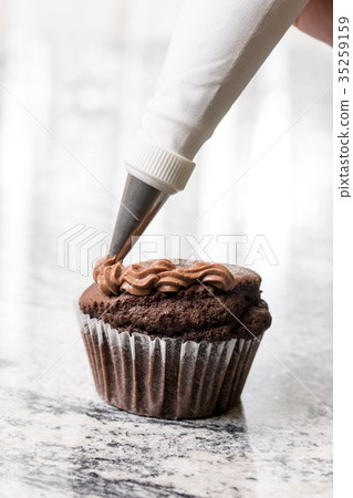 Piping bag with chocolate ganache cream Piping bag with chocolate ganache cream 35259159