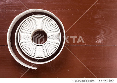 White sanitary sealant strip on the wooden brown White sanitary sealant strip on the wooden brown 35260168