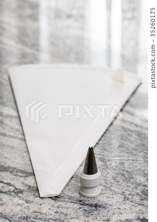 White pastry piping bag on the grey granite 35260175