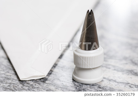 White pastry piping bag on the grey granite 35260179