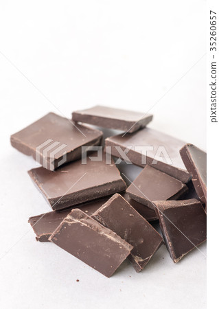 Slices of cooking chocolate on the white marble 35260657