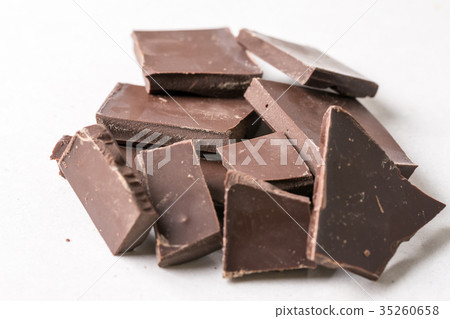 Slices of cooking chocolate on the white marble Slices of cooking chocolate on the white marble 35260658