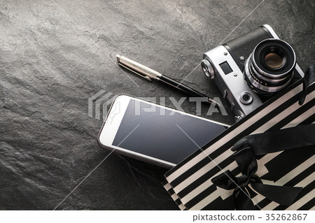 Phone, camera, pen in a black bag with white Phone, camera, pen in a black bag with white 35262867