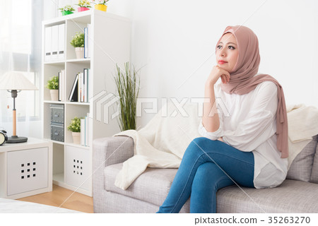 smiling beauty muslim woman sitting on sofa couch smiling beauty muslim woman sitting on sofa couch 35263270