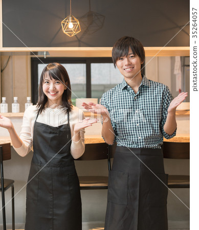 Men and women working at a cafe 35264057