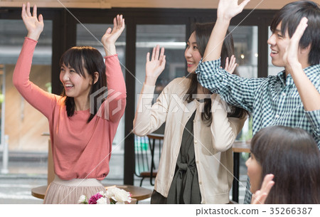 Men and women raising hands with both hands 35266387