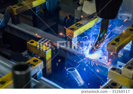 The robot is welding the work piece. The robot is welding the work piece. 35268517
