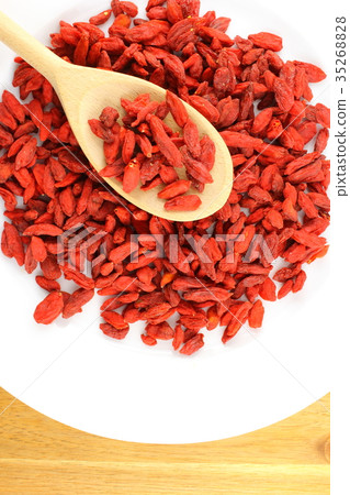 dried goji berries on a wooden spoon 35268828