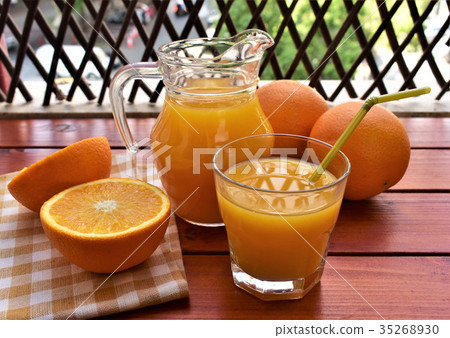 Fresh orange juice on the veranda table. Fresh orange juice on the veranda table. 35268930