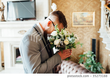 stylish groom holding bridal bouquet stylish groom holding bridal bouquet 35273188