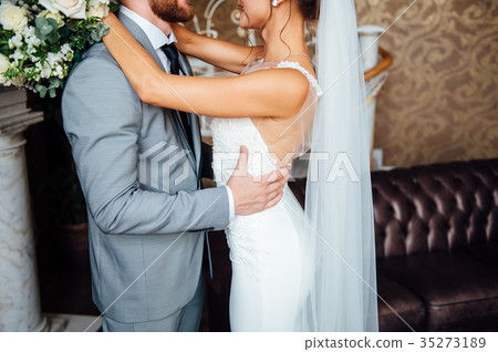 stylish bride and groom are holding bridal bouquet 35273189