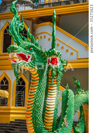 Green naka statue in front of Thai Buddhist Green naka statue in front of Thai Buddhist 35273823