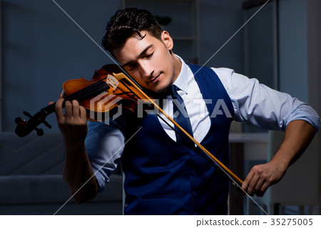 Young musician man practicing playing violin at Young musician man practicing playing violin at 35275005