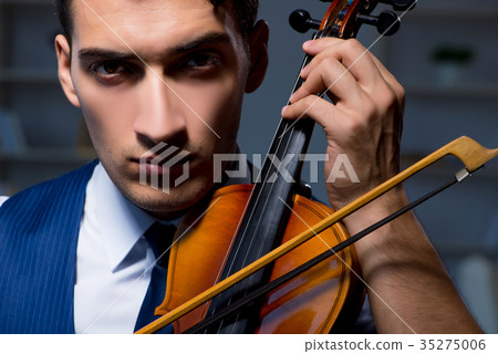Young musician man practicing playing violin at 35275006