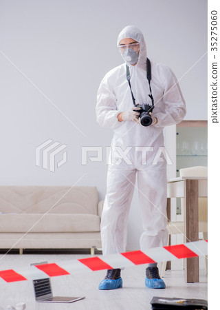 Forensic expert at crime scene doing investigation 35275060