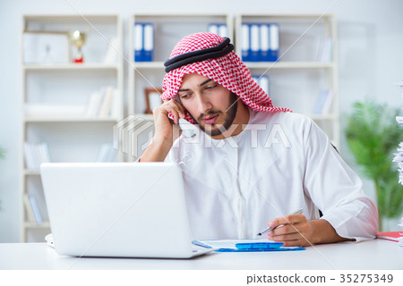 Arab businessman working in the office doing Arab businessman working in the office doing 35275349