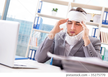 Injured businessman working in the office Injured businessman working in the office 35275770