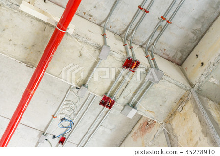 fire sprinkler on red pipe hanging from ceiling  35278910