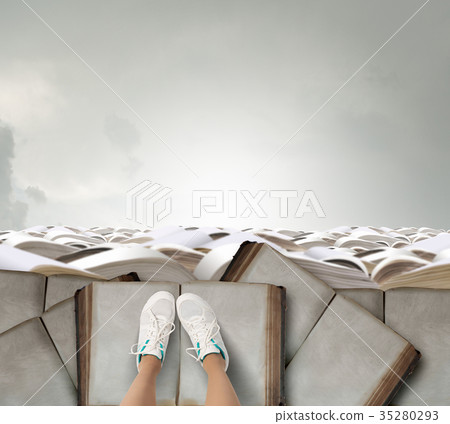 On pile of books 35280293