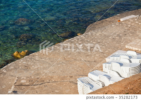 Plastic Poolside Chairs in a pile 35282173