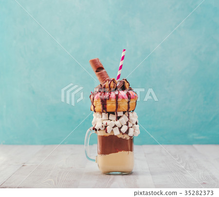 Freakshake with donuts on gray wooden background 35282373
