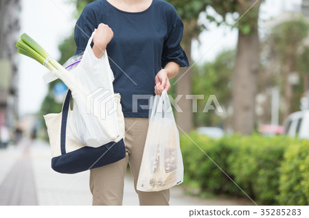 Woman with plastic shopping bag Woman with plastic shopping bag 35285283