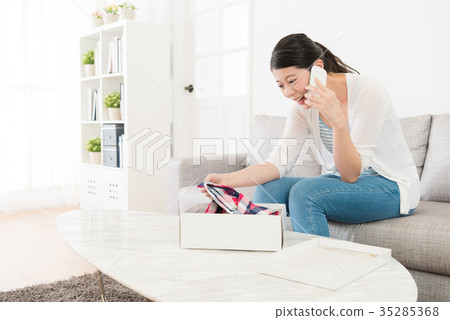 happy young woman received clothing gift package 35285368