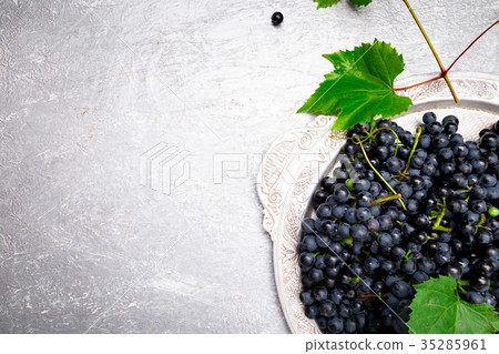 Red wine grapes in silver tray on grey background 35285961