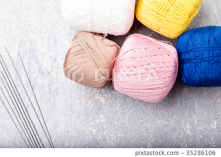 Multicolor knitting ball and needles on grey Multicolor knitting ball and needles on grey 35286106