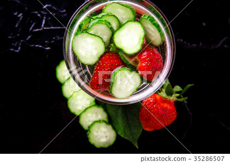Cucumber and strawberry detox water in glass Cucumber and strawberry detox water in glass 35286507
