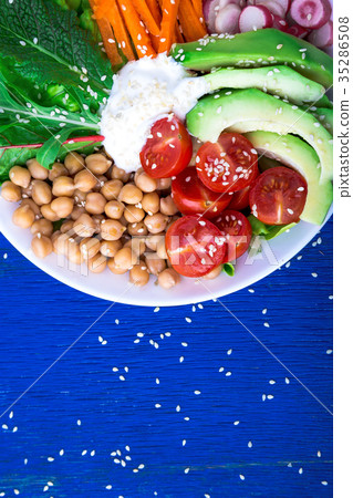 Vegan buddha bowl on blue wooden background Vegan buddha bowl on blue wooden background 35286508